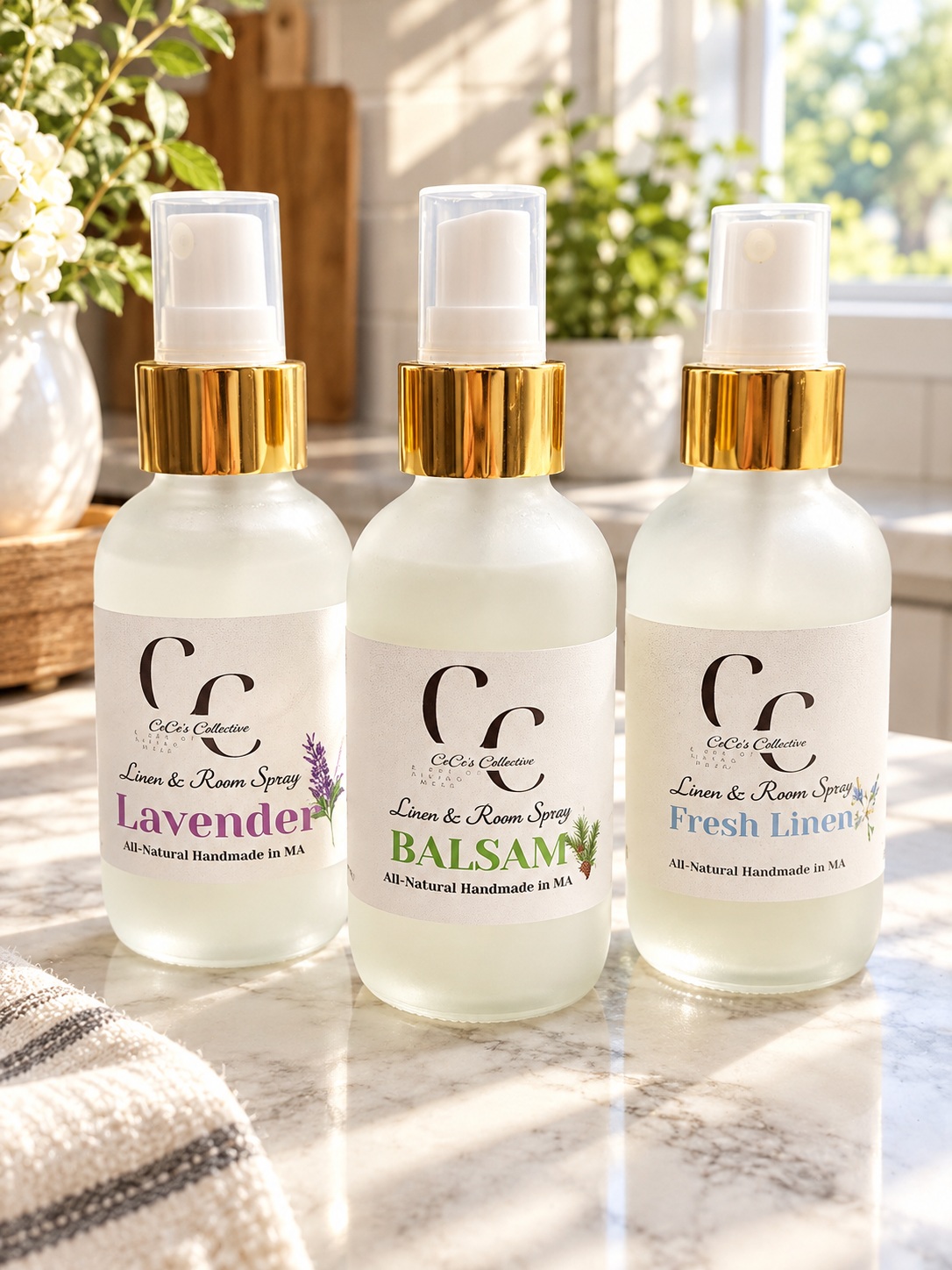 CeCe's Collective Linen & Room Spray in Lavender, Balsam, and Fresh Linen fragrances — frosted white bottles with gold pump tops on a marble surface